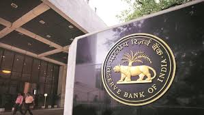 RBI Mumbai headquarters with downward interest rate arrow graph